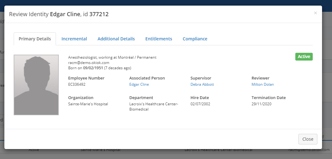 A Review Identity modal on its Primary Details tab, showing the person’s title and location, employee number, associated person, supervisor, reviewer, organization, department, hire date and termination date, with an Active badge.